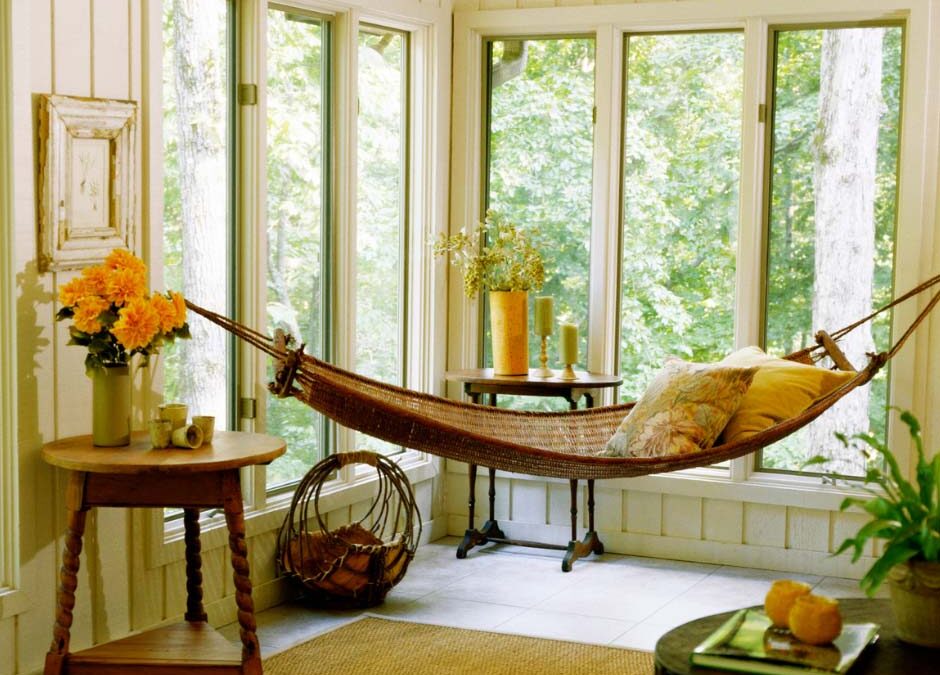 A cozy hammock suspended in a bright room, surrounded by plants and soft lighting, inviting relaxation.